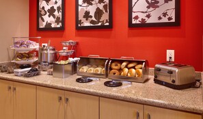 A breakfast buffet with various food items and a toaster on a counter. - TownePlace Suites by Marriott Elko (Elko)