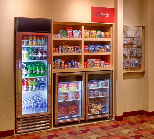 A vending area with various snacks, beverages, and a sign reading "In a Pinch".
