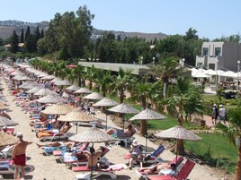 Playa privada, sillas reclinables de playa, sombrillas, toallas de playa