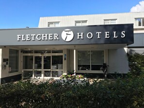 The Fletcher Hotels entrance with a modern design, featuring a prominent logo and a glass facade. - Fletcher Hotel - Restaurant Waalwijk (Waalwijk)