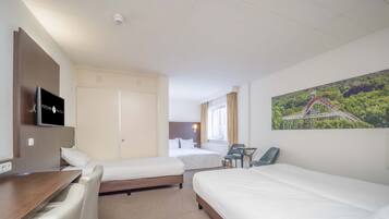 A hotel room with two beds, a desk, a chair, a TV, a window with curtains, and a painting of a roller coaster.