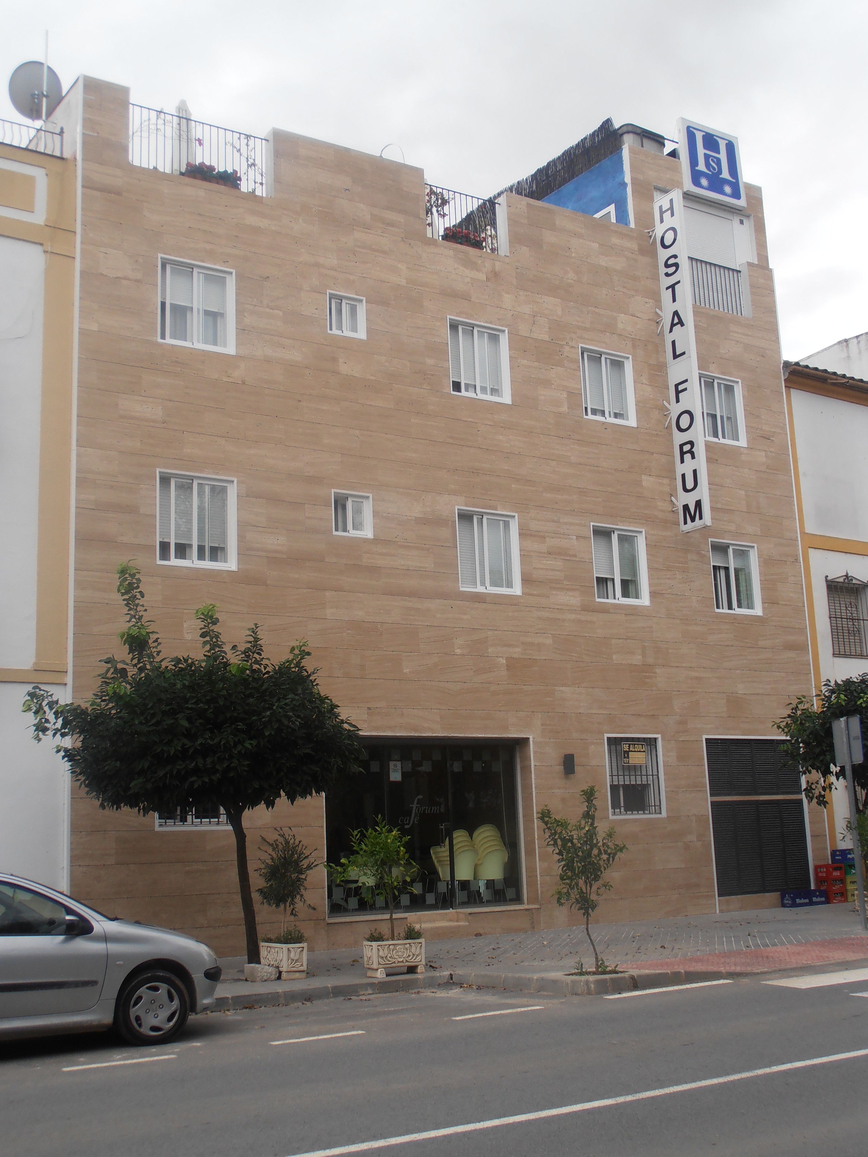 A multi-story building with a sign reading "HOSTAL FORUM".