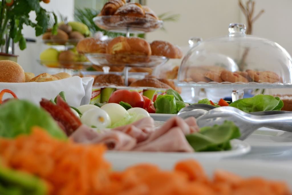 Ein Buffet mit verschiedenen Speisen, darunter Gebäck, Fleisch und Gemüse.
