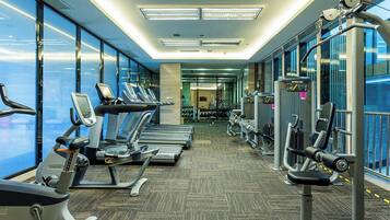A gym with treadmills, ellipticals, and weight machines.