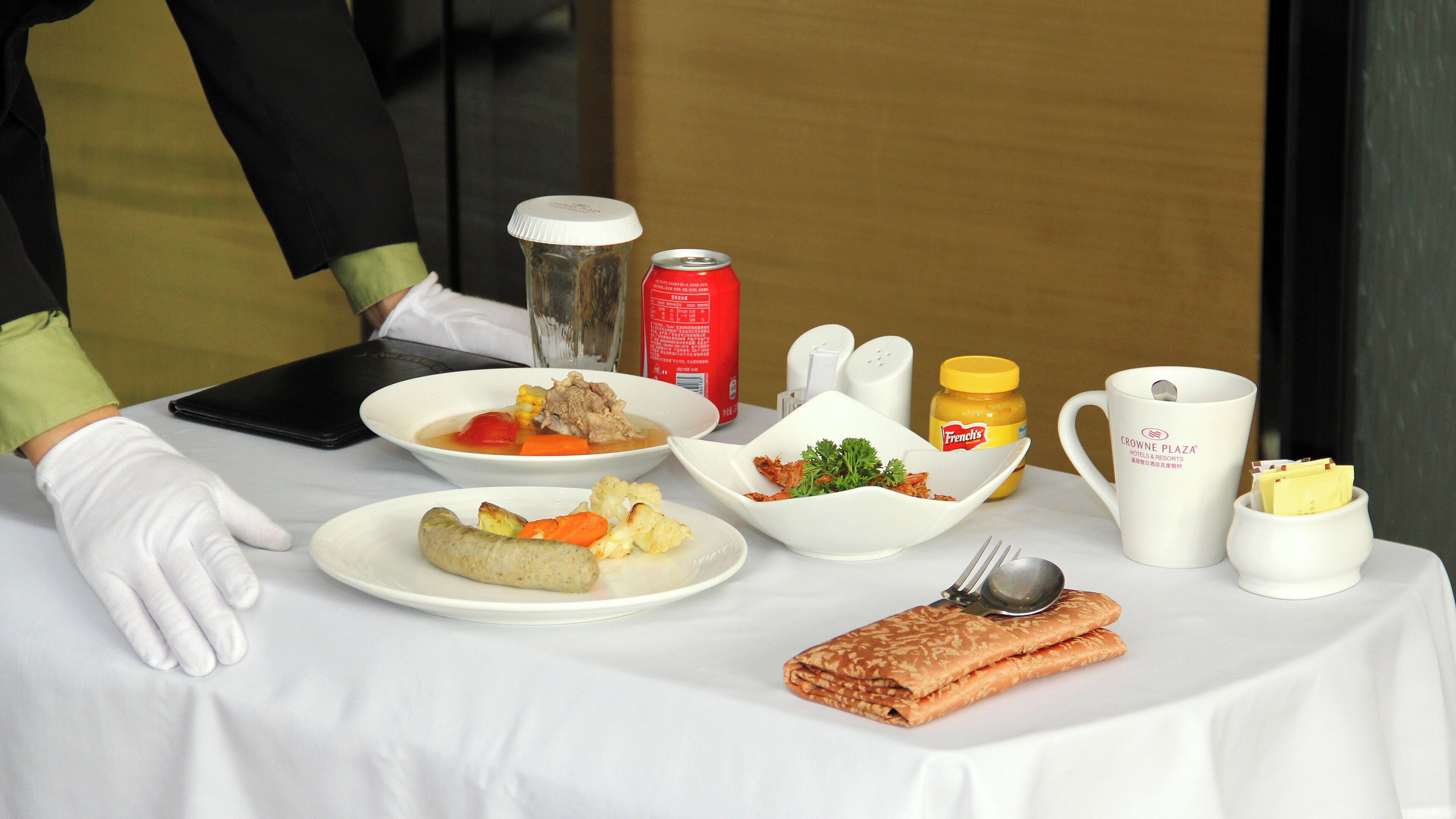 A table set with various dishes, condiments, and a spoon.