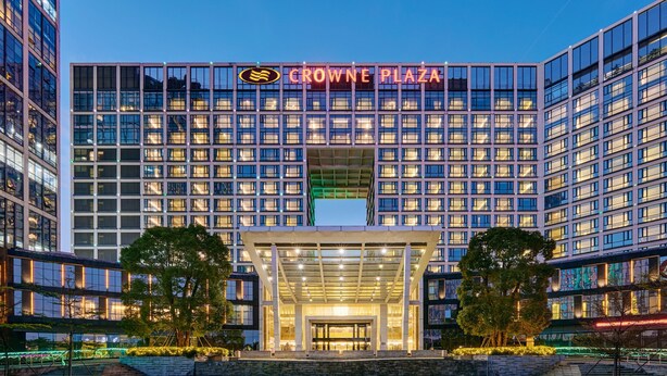 A modern building with a large sign reading "CROWNE PLAZA". - Crowne Plaza Shenzhen Longgang City Centre by IHG (Shenzhen)