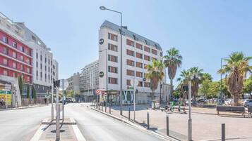 A multi-story hotel with a modern design, featuring balconies and a prominent 'B&B' sign.
