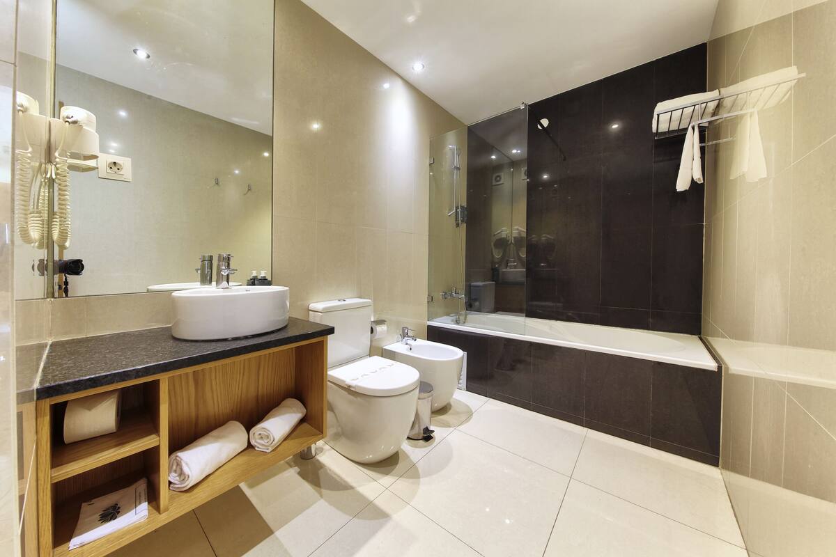 designer toiletries, hair dryer, towels, soap