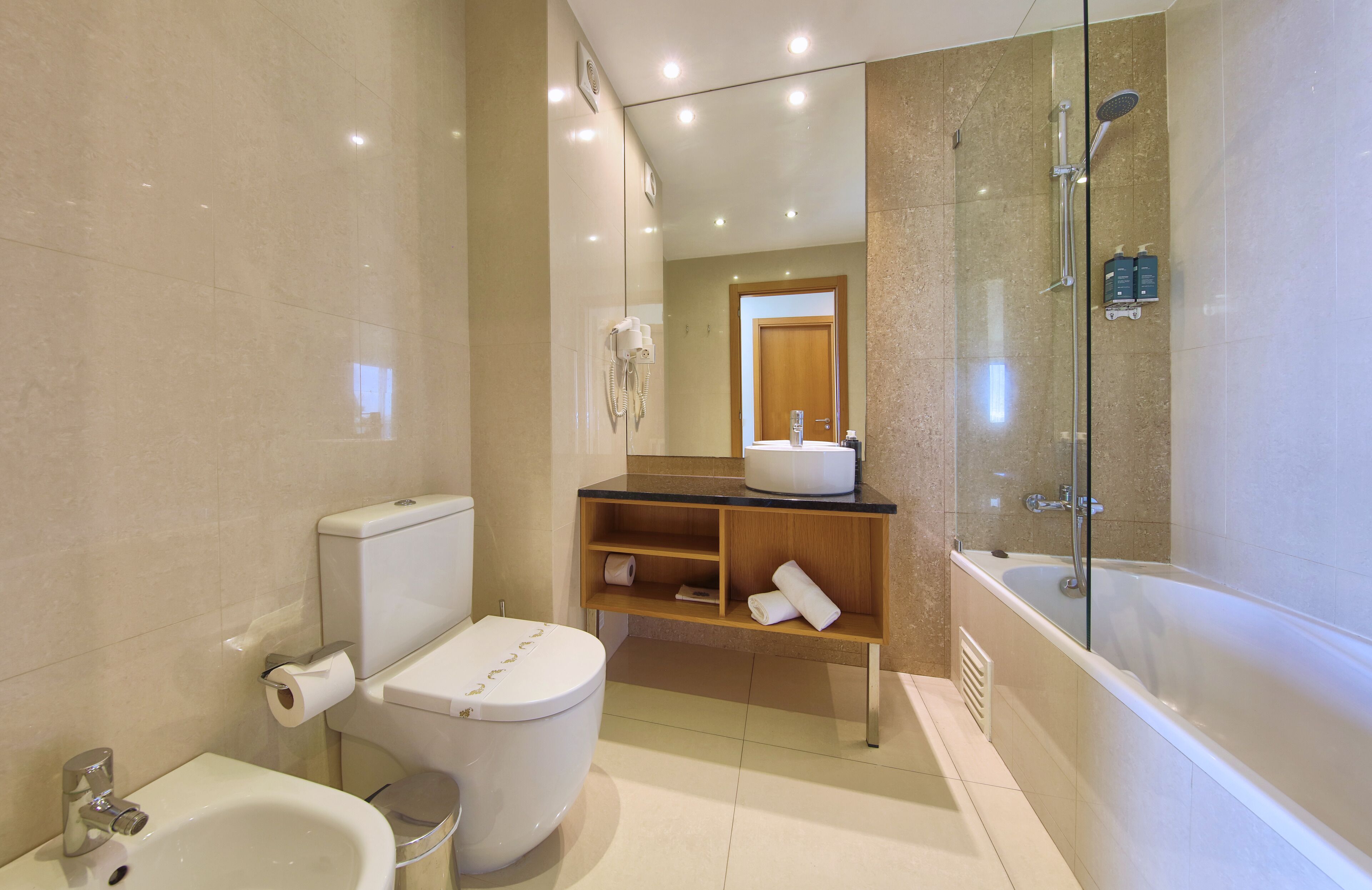 designer toiletries, hair dryer, towels, soap