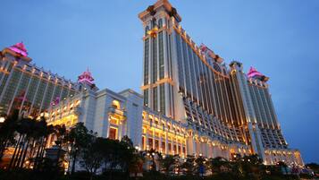 A multi-story hotel with a classic architectural design, featuring large windows and decorative elements on the facade.
