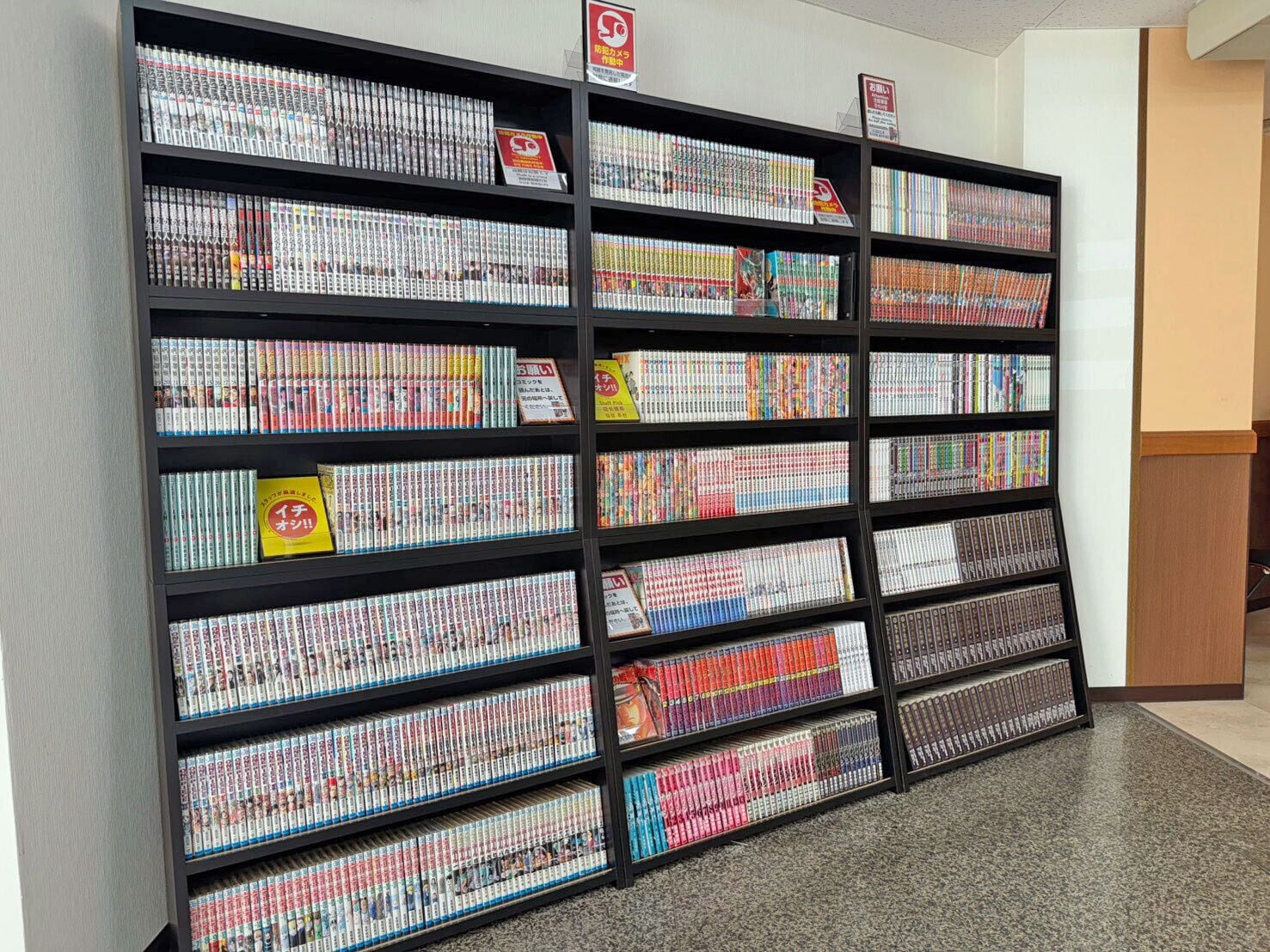 A large bookshelf filled with magazines and books, arranged in multiple rows and columns.