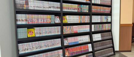 A large bookshelf filled with magazines and books, arranged in multiple rows and columns.