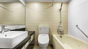 A modern bathroom with a sink, toilet, and bathtub.