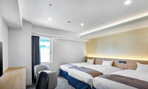 A hotel room with two beds, a desk, a chair, and a large window.