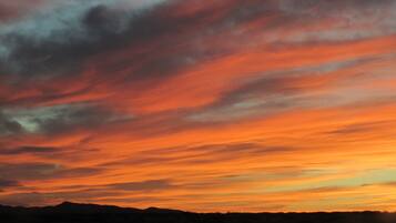A sunset over a mountainous landscape.