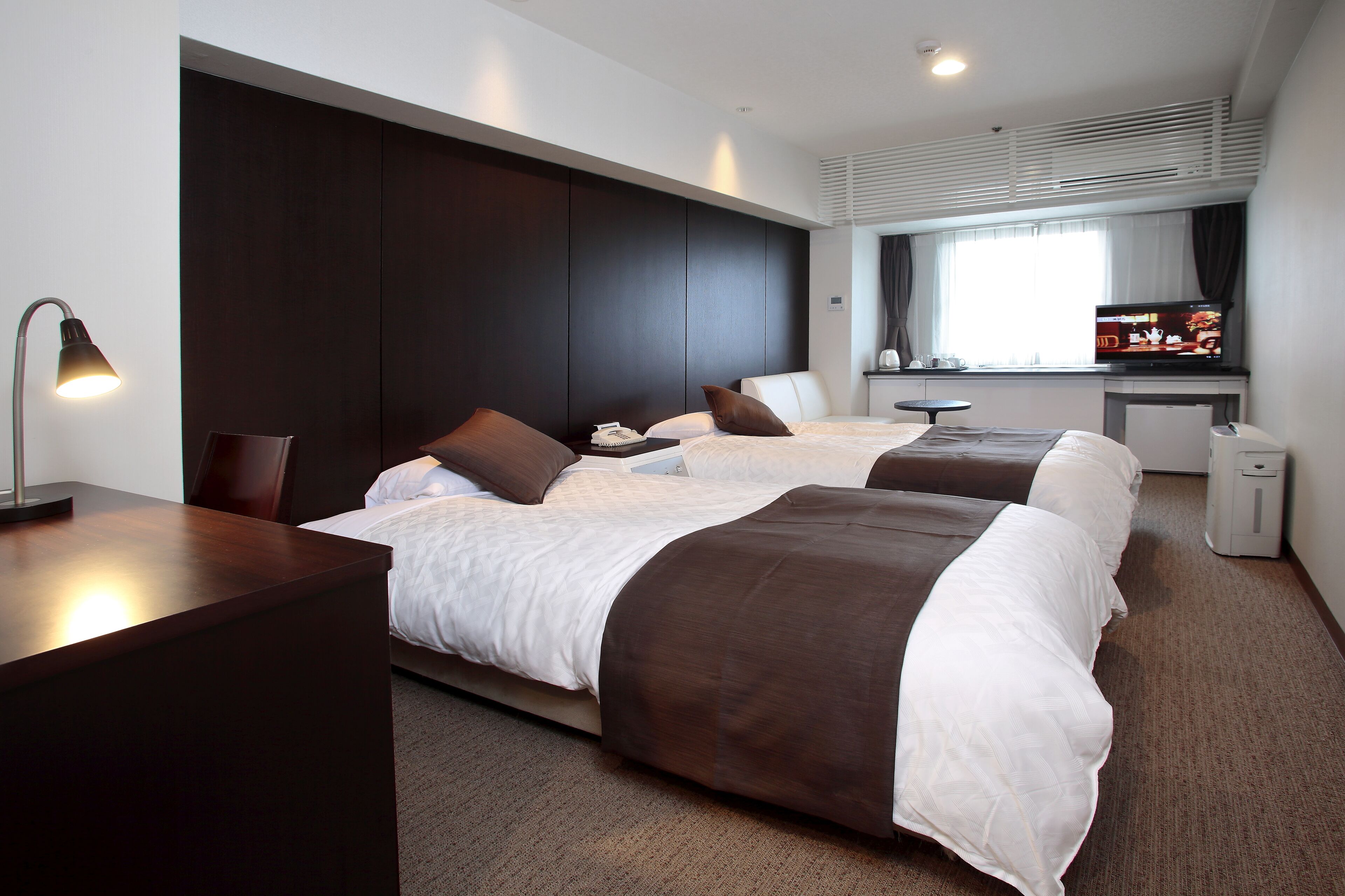 Premium bedding, laptop workspace, blackout drapes, soundproofing