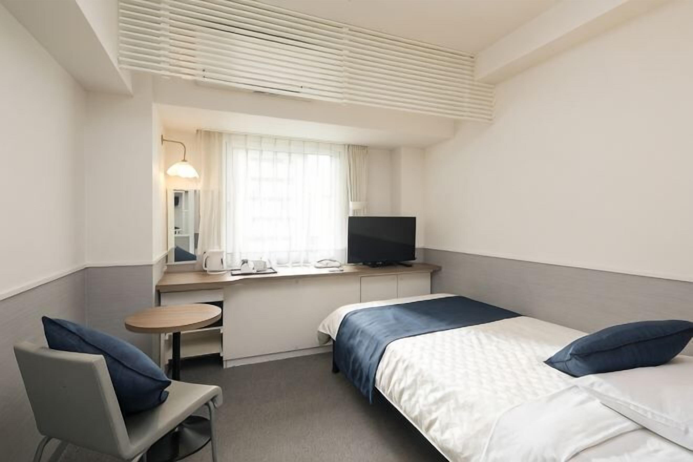 Premium bedding, laptop workspace, blackout drapes, soundproofing