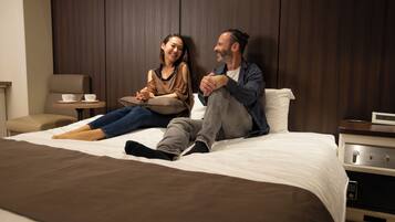 Premium bedding, laptop workspace, blackout drapes, soundproofing