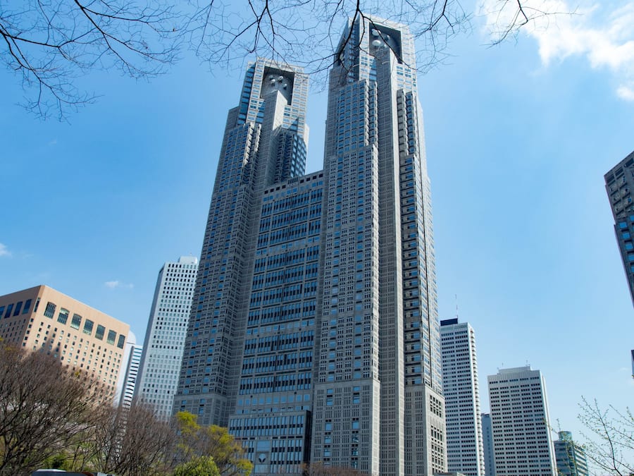 A tall, modern skyscraper with a distinctive top section and numerous windows.