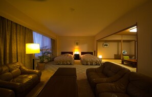 Deluxe Quadruple Room, Mountain View | Living area | TV