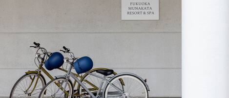 A bicycle parked in front of a sign for Fukuoka Munakata Resort & Spa.