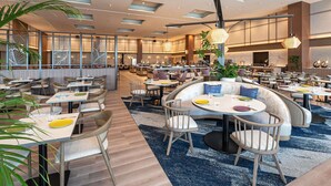A spacious hotel lobby with multiple seating areas, including round tables and booths, and a central staircase. - Grand Mercure Wakayama Minabe Resort & Spa (Minabe)