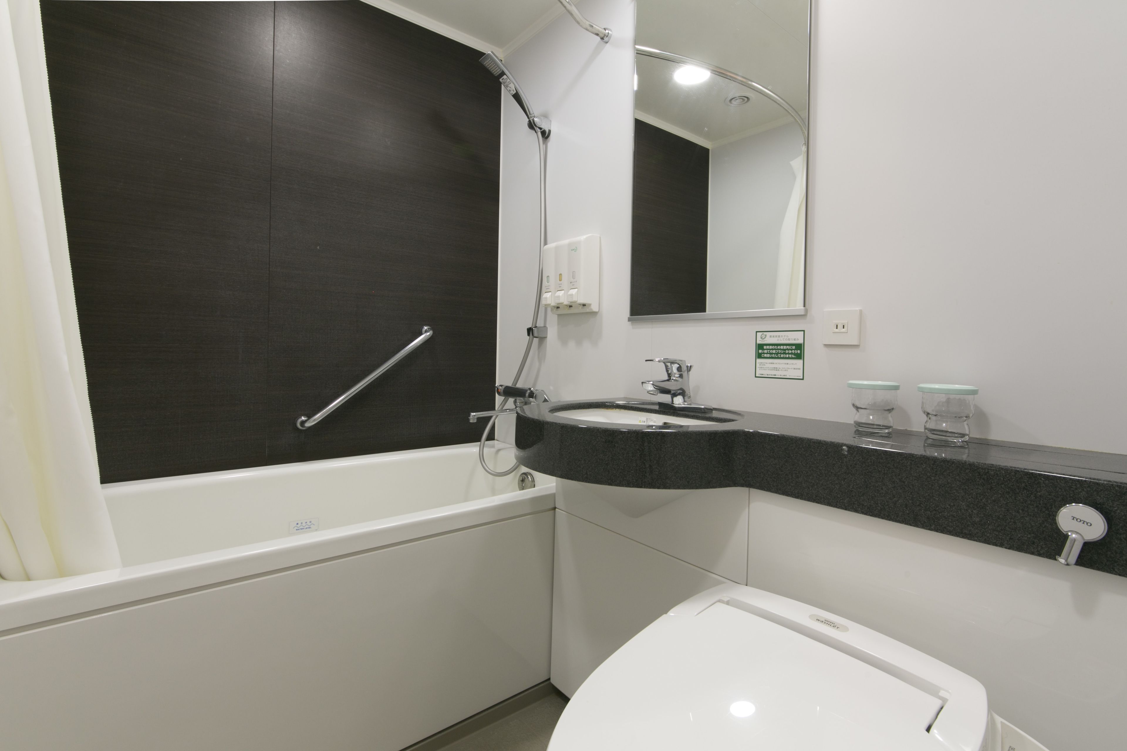 A modern bathroom with a bathtub, a sink, and a toilet.