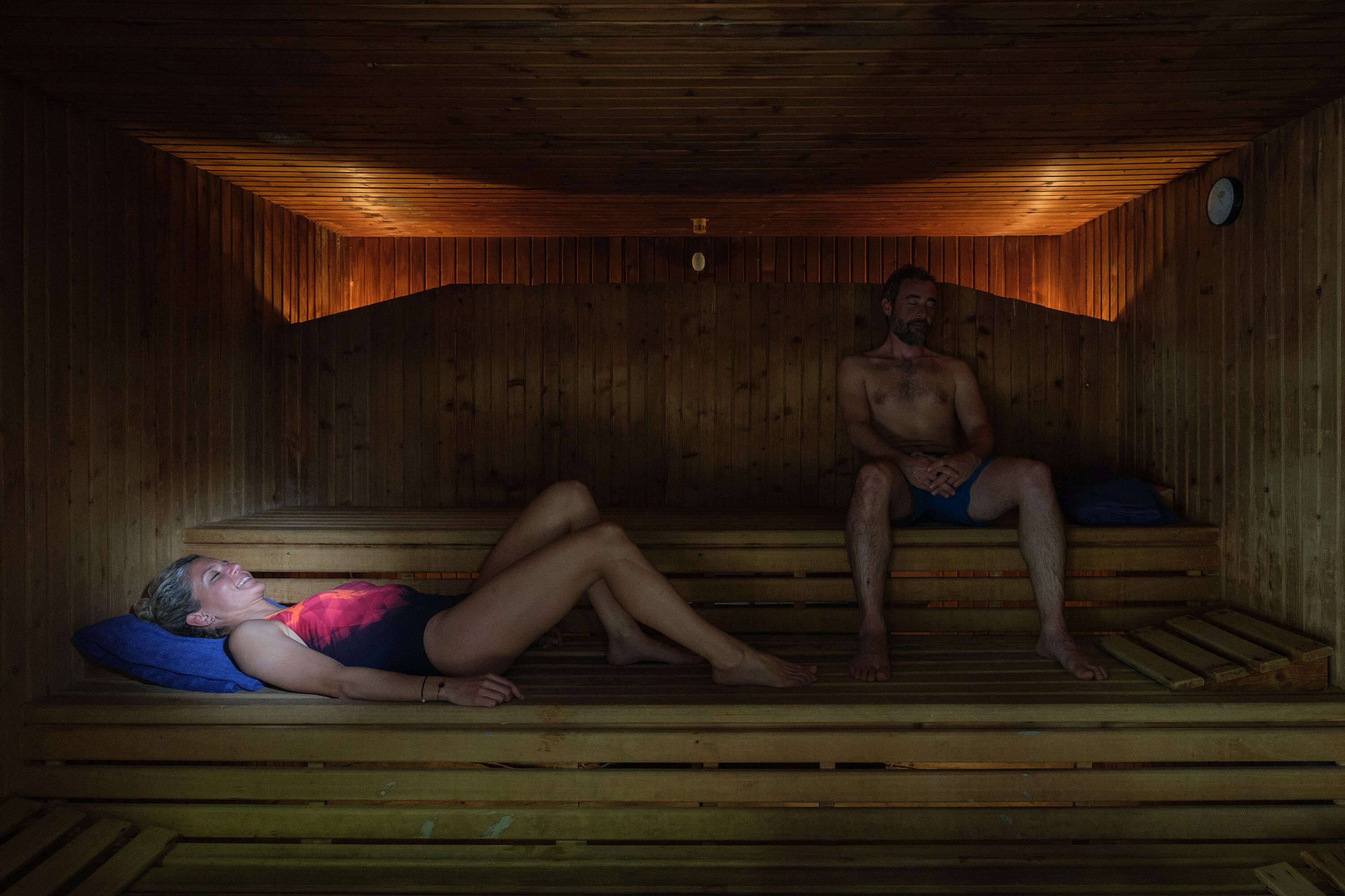 A sauna room with wooden benches and benches.