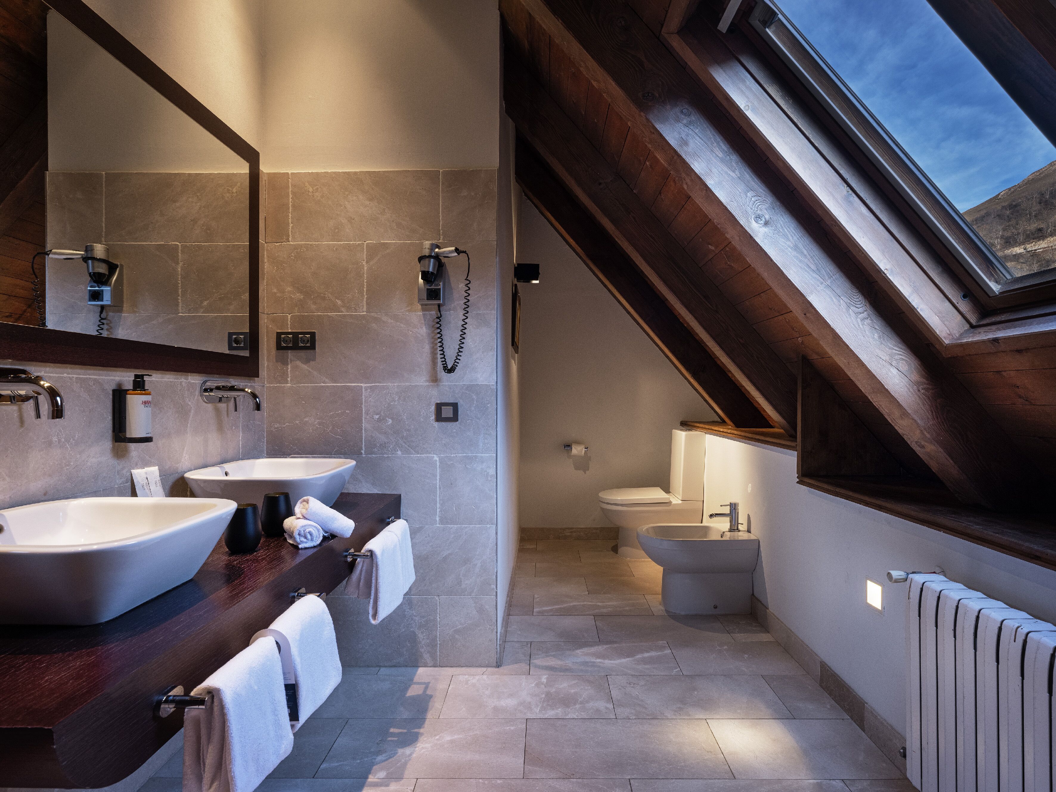 designer toiletries, hair dryer, bidet, towels