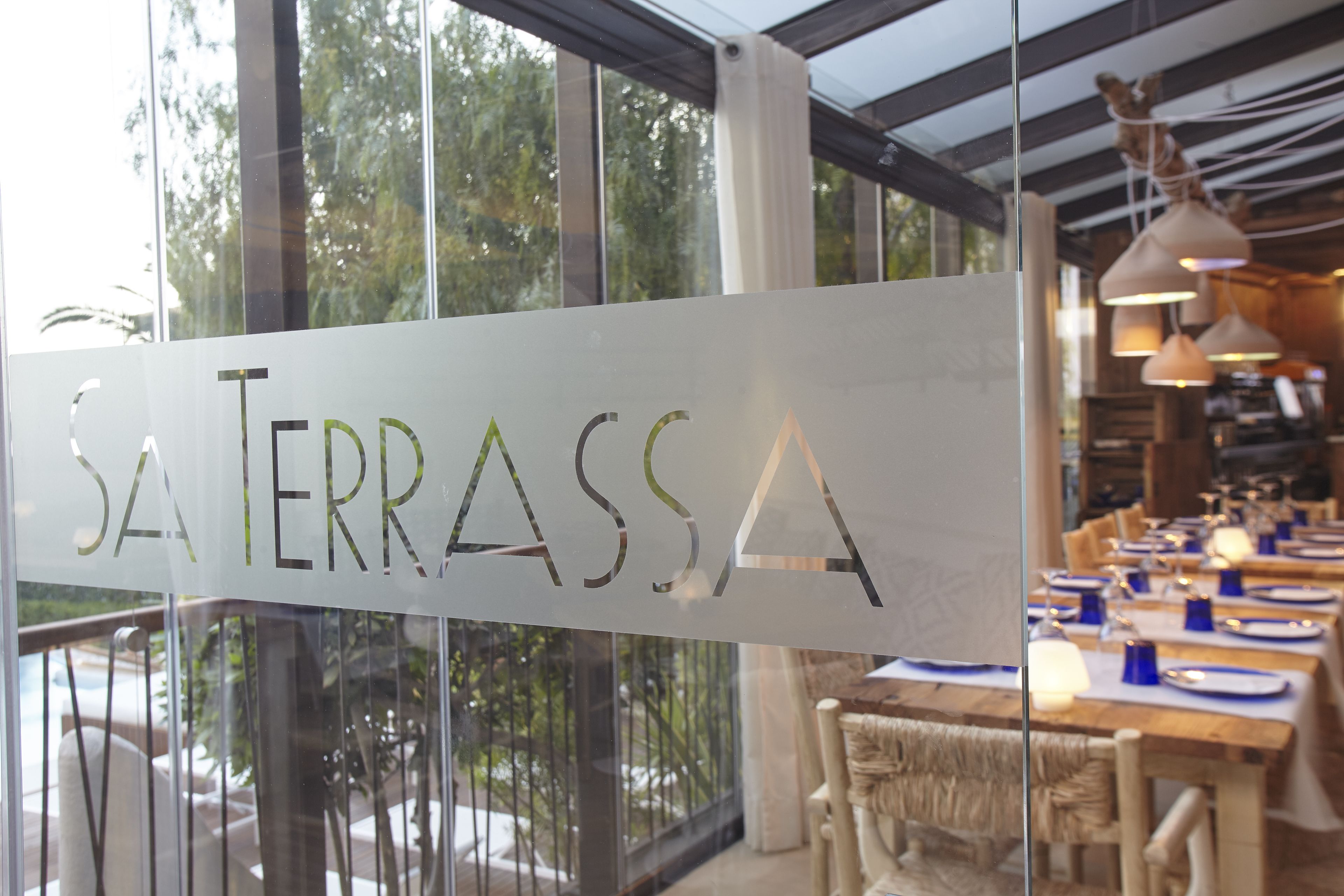 A restaurant interior with a sign reading "SA TERRASSA".