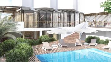 A modern outdoor pool area with lounge chairs, a wooden deck, and a glass-enclosed upper level with a dining area.