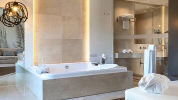 A modern bathroom with a large bathtub, a glass-enclosed shower, and a vanity with a mirror.