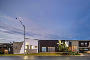 Hotel building with a contemporary design, situated on a street corner.