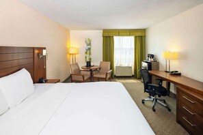 Relax in comfort with a large bed, desk, and TV, plus a coffee maker and small table for work and relaxation.