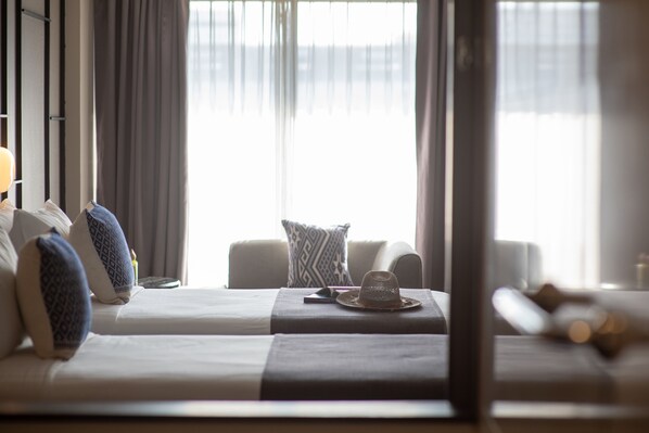A hotel room with two beds, a sofa, and a window with curtains. - Page 10, Hotel (Pattaya)