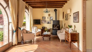 A living room with a fireplace, comfortable seating, and a television.