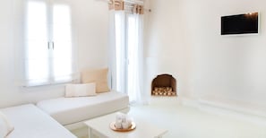 Deluxe suite, gedeeltelijk uitzicht op zee | Woonkamer | Flatscreentelevisie