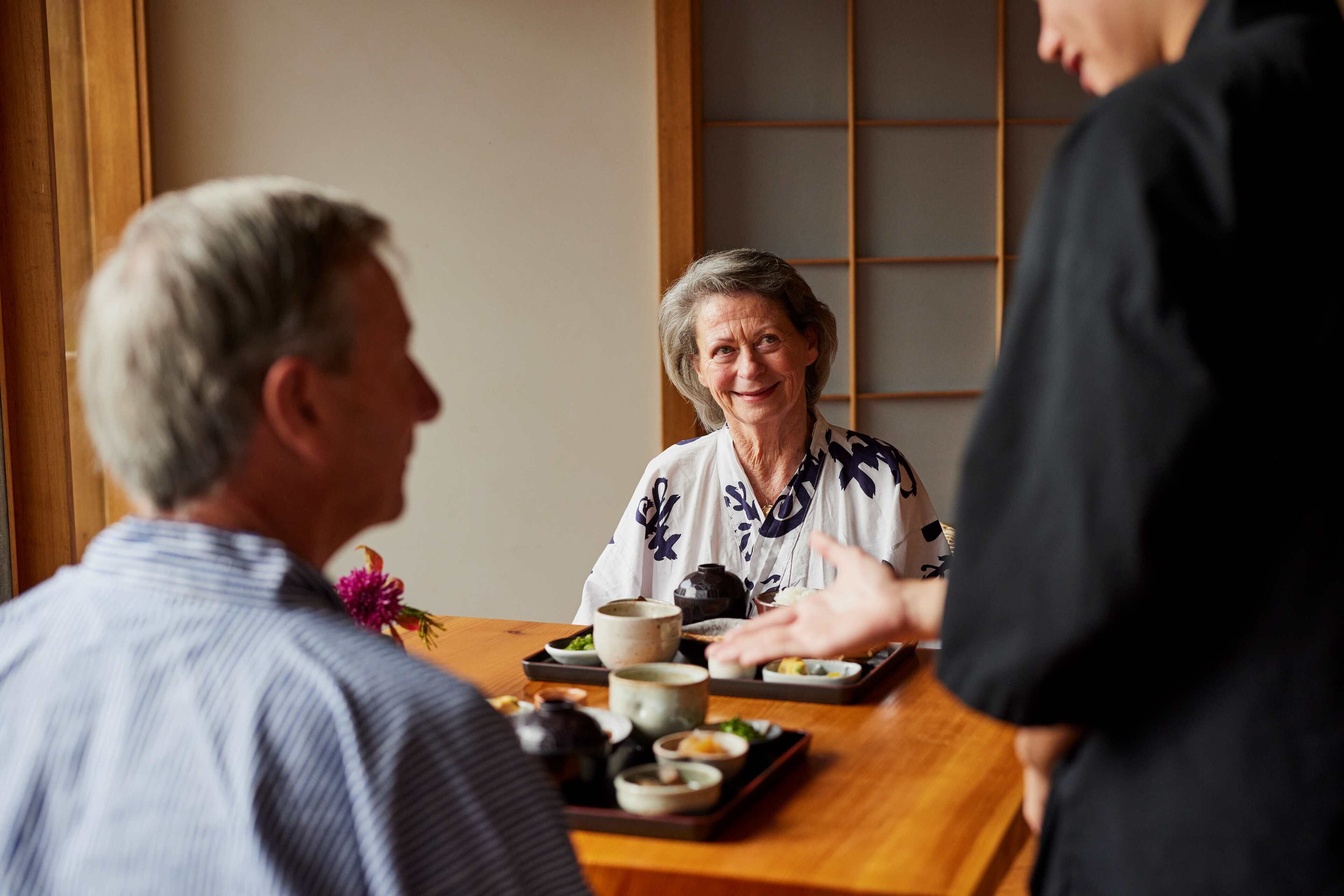 A dining table with traditional Japanese dishes and tea set.