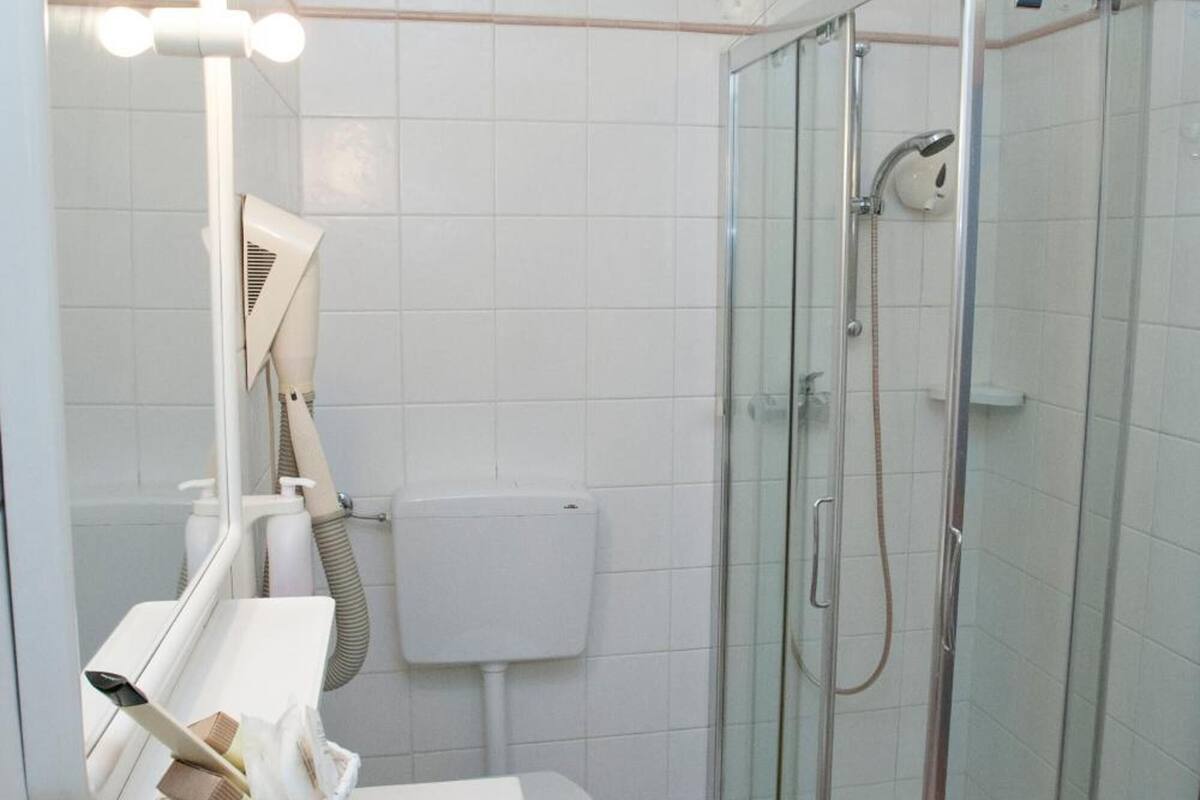 bathtub, hair dryer, slippers, towels