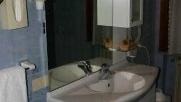 A bathroom with a double sink, a mirror, and a cabinet.