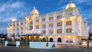 A grand hotel with multiple domed structures, a well-lit facade, and a formal entrance. - Fortune JP Palace, Mysore - Member ITC Hotels' Group (Mysore)