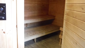 A wooden sauna with a bench and steps. - Rangeley Lake Resort (Rangeley)