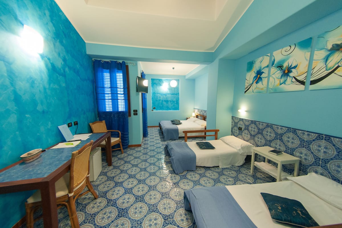 Quadruple Room | Minibar, in-room safe, individually decorated, individually furnished