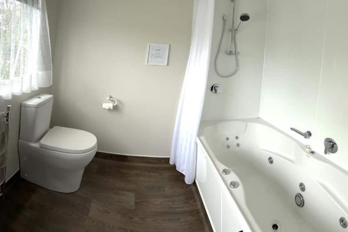 A bathroom with a sink, toilet, and bathtub.