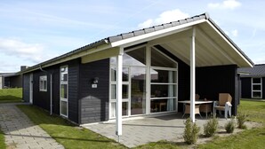 A modern building with large windows and a covered patio area. - Lalandia Resort Billund (Billund)