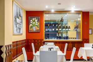 Enjoy a casual dining experience with comfortable seating and a selection of beverages on display.