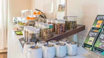A buffet area with various food items and tea options.