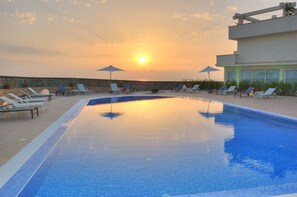 Seasonal outdoor pool, open 10:00 AM to 7:30 PM, pool umbrellas