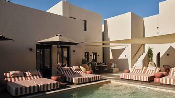 Outdoor pool, open 10 AM to 7 PM, pool loungers