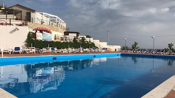 Outdoor pool, open 9:00 AM to 7:00 PM, pool umbrellas, pool loungers